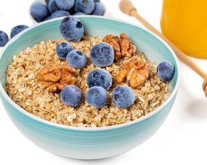 Preview wallpaper oatmeal, berries, nuts, bowl, breakfast