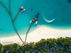 Preview wallpaper ocean, aerial view, coast, bungalow, palm trees