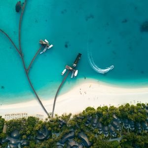 Preview wallpaper ocean, aerial view, coast, bungalow, palm trees