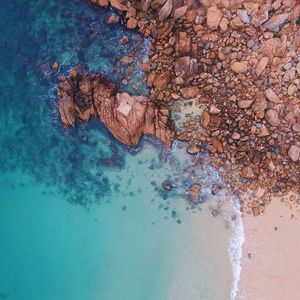 Preview wallpaper ocean, aerial view, stones, water, sand