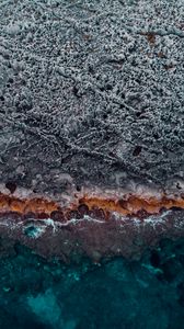 Preview wallpaper ocean, coast, aerial view, water, stones, surface, ribbed