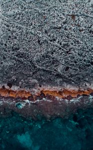 Preview wallpaper ocean, coast, aerial view, water, stones, surface, ribbed