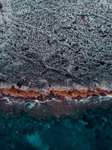 Preview wallpaper ocean, coast, aerial view, water, stones, surface, ribbed
