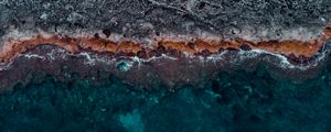 Preview wallpaper ocean, coast, aerial view, water, stones, surface, ribbed