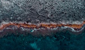 Preview wallpaper ocean, coast, aerial view, water, stones, surface, ribbed