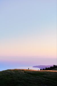 Preview wallpaper ocean, coast, horizon, hills, silhouette, fog
