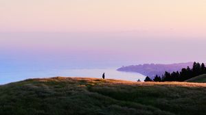 Preview wallpaper ocean, coast, horizon, hills, silhouette, fog