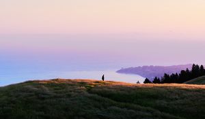 Preview wallpaper ocean, coast, horizon, hills, silhouette, fog