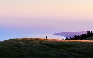 Preview wallpaper ocean, coast, horizon, hills, silhouette, fog