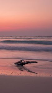 Preview wallpaper ocean, coast, sunset, cobble, sand, horizon