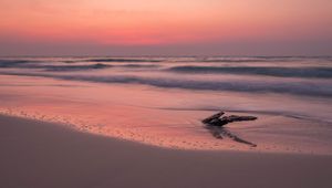 Preview wallpaper ocean, coast, sunset, cobble, sand, horizon