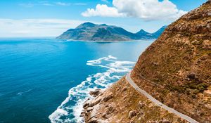 Preview wallpaper ocean, mountain, road, turn, sky