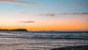 Preview wallpaper ocean, rocks, city, horizon