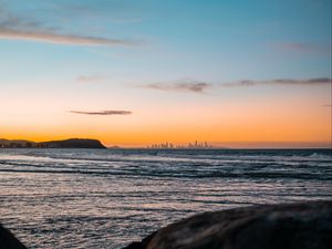 Preview wallpaper ocean, rocks, city, horizon