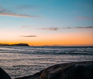 Preview wallpaper ocean, rocks, city, horizon