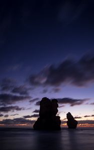 Preview wallpaper ocean, rocks, clouds, dark, twilight