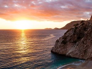 Preview wallpaper ocean, rocks, sunset, coast, sea