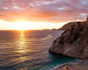 Preview wallpaper ocean, rocks, sunset, coast, sea