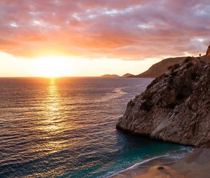 Preview wallpaper ocean, rocks, sunset, coast, sea