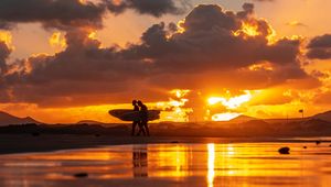 Preview wallpaper ocean, silhouettes, surfing, surfers, sunset