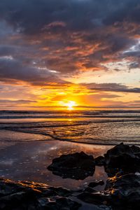 Preview wallpaper ocean, stones, horizon, sunset, dark