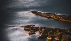 Preview wallpaper ocean, stones, surface, water, twilight