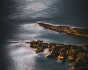 Preview wallpaper ocean, stones, surface, water, twilight