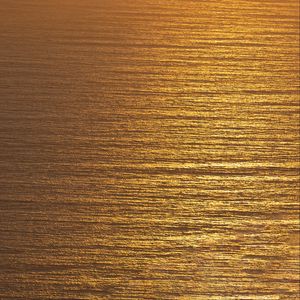 Preview wallpaper ocean, sunset, aerial view, ripples, waves, water