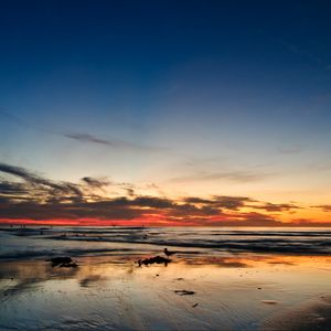 Preview wallpaper ocean, sunset, horizon, sand, silhouettes, california