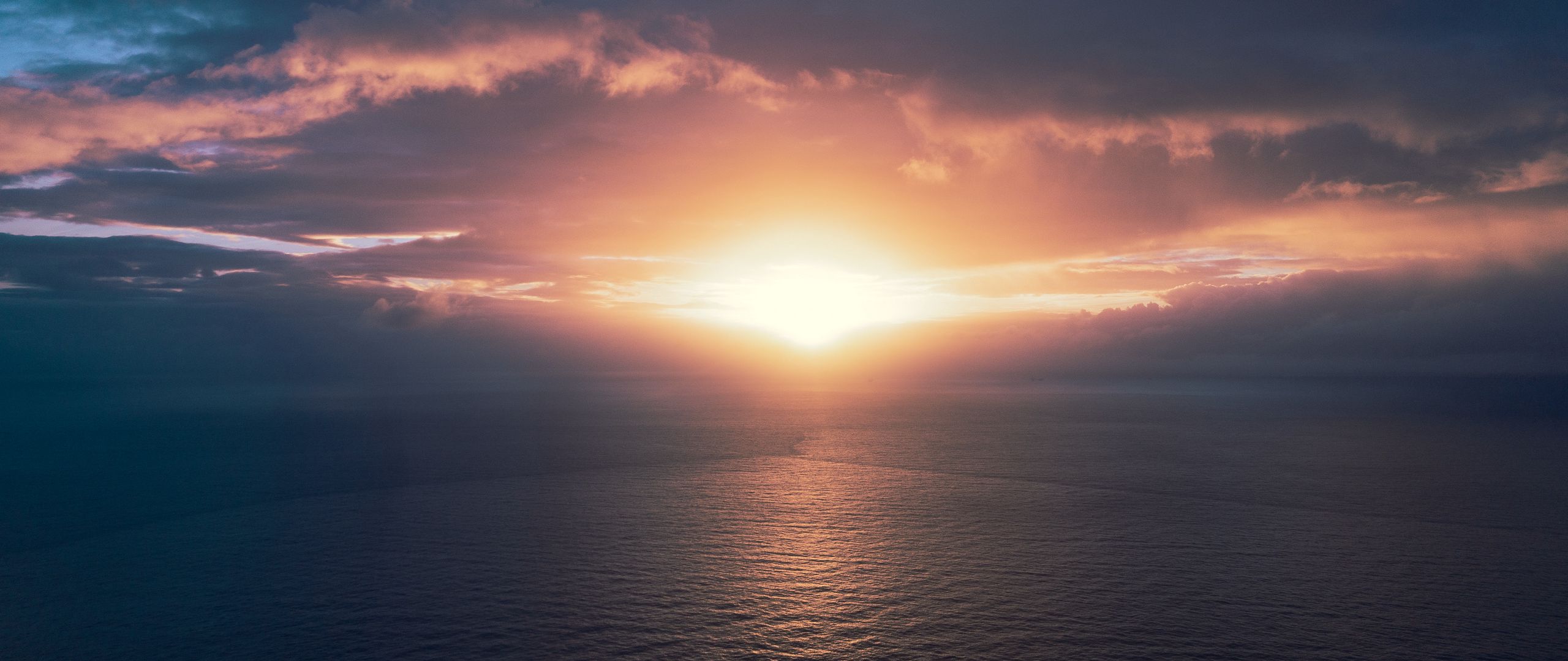 Download wallpaper 2560x1080 ocean, sunset, horizon, sky, clouds