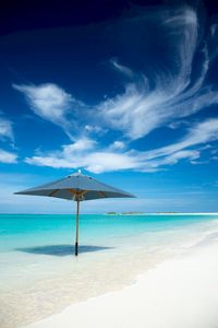 Preview wallpaper ocean, umbrella, horizon, clouds, tropics, shore