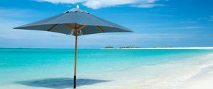 Preview wallpaper ocean, umbrella, horizon, clouds, tropics, shore