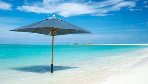 Preview wallpaper ocean, umbrella, horizon, clouds, tropics, shore