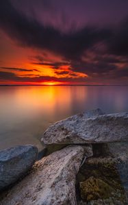 Preview wallpaper ocean, water, stones, horizon, sunset