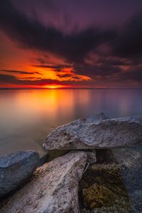 Preview wallpaper ocean, water, stones, horizon, sunset