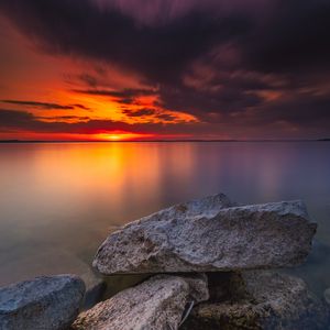 Preview wallpaper ocean, water, stones, horizon, sunset