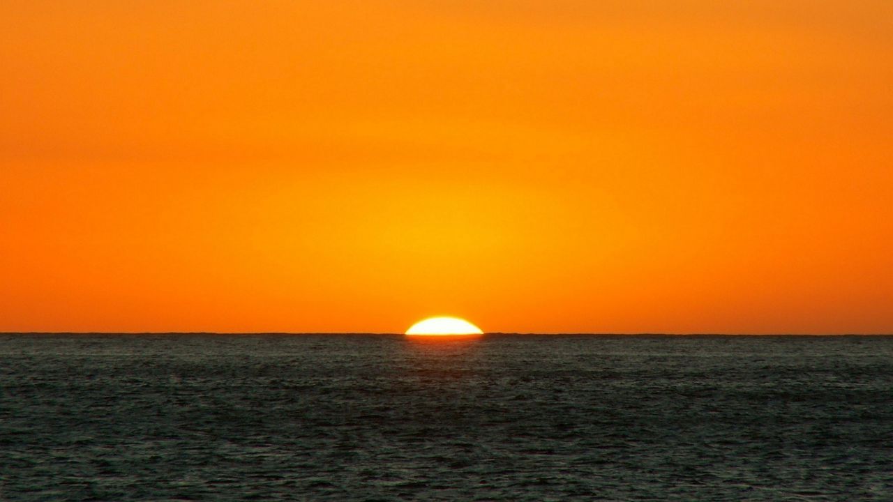 Wallpaper orange, dark blue, sea, horizon, sun