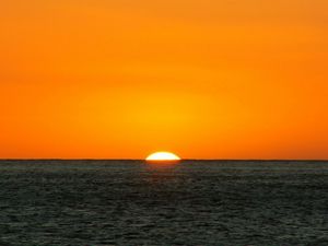 Preview wallpaper orange, dark blue, sea, horizon, sun