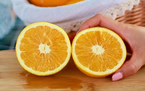 Preview wallpaper orange, fruit, citrus, slices, hand