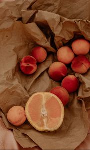 Preview wallpaper orange, nectarines, fruit, paper, crumpled