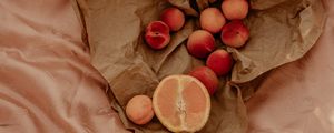 Preview wallpaper orange, nectarines, fruit, paper, crumpled