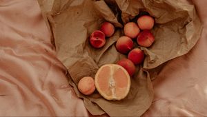 Preview wallpaper orange, nectarines, fruit, paper, crumpled