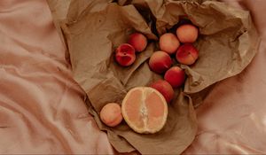 Preview wallpaper orange, nectarines, fruit, paper, crumpled