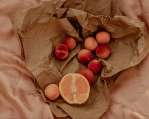 Preview wallpaper orange, nectarines, fruit, paper, crumpled