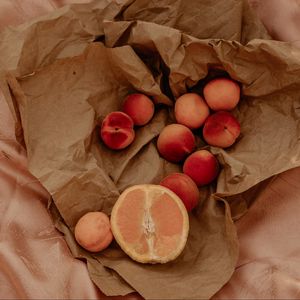 Preview wallpaper orange, nectarines, fruit, paper, crumpled