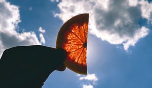 Preview wallpaper orange, slice, hand, clouds, sky