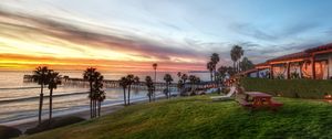 Preview wallpaper palm trees, coast, sea, table, benches, picnic, slope, evening