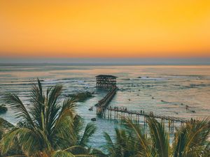 Preview wallpaper palm trees, ocean, sunset, pier, building