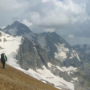 Preview wallpaper panorama, mountains, person, ascension, climber, loneliness