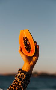 Preview wallpaper papaya, fruit, exotic, hand